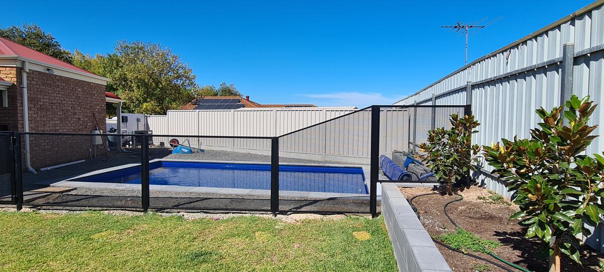 Pure Perf pool fencing in Textured Black around a backyard pool and lawn, SA
