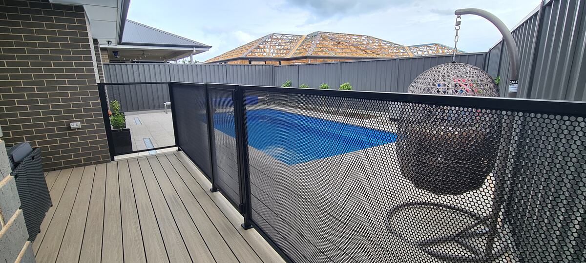 Pure Perf pool fence beside a deck with hanging chair, SA
