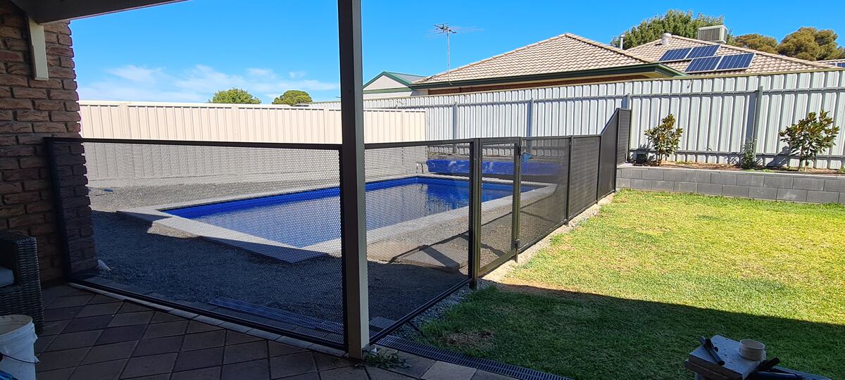 Pure Perf Textured Black pool fencing with lawn and pool cover, SA