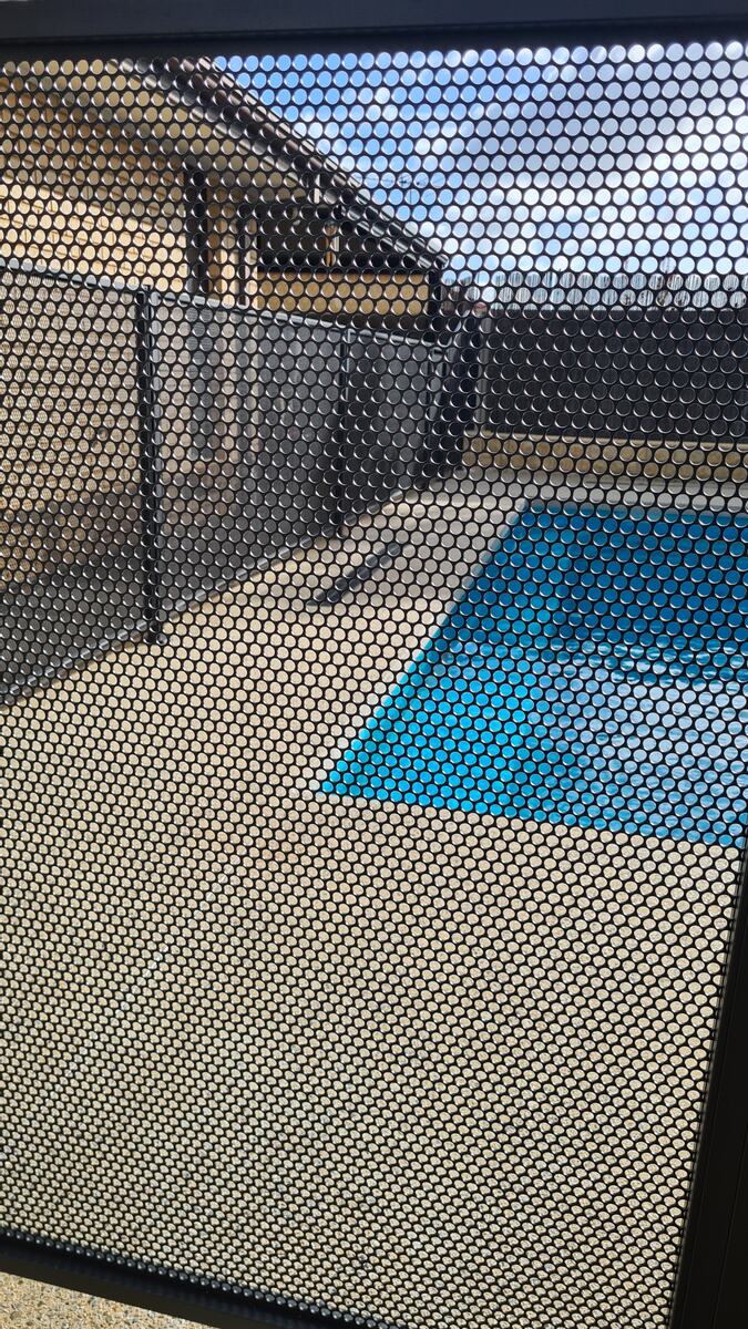 Pure Perf perforated panel detail beside a swimming pool, SA