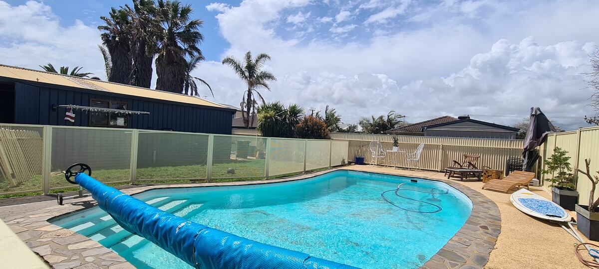 Pure Perf pool fencing in Textured Primrose around a kidney-shaped pool, SA