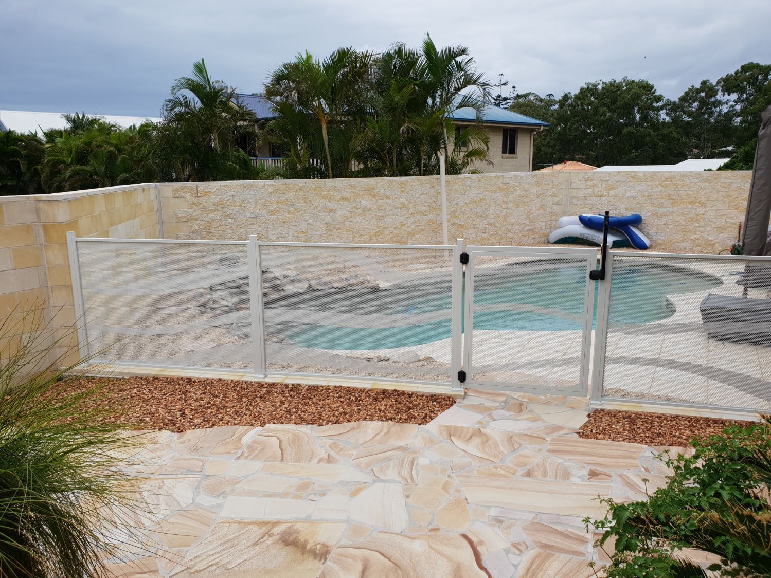 Wave design pool fencing in white, Queensland